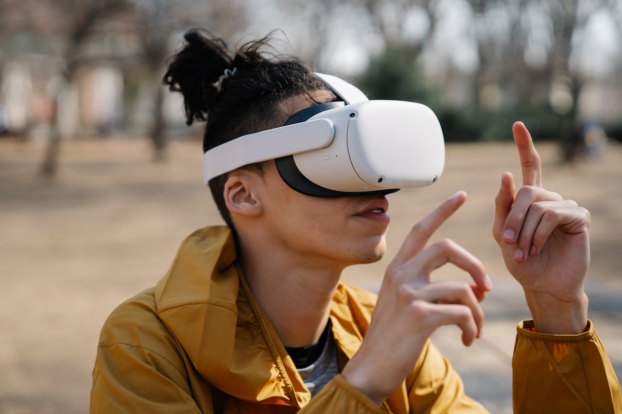 Shocked young male with long hair using virtual reality headset in park on autumn day